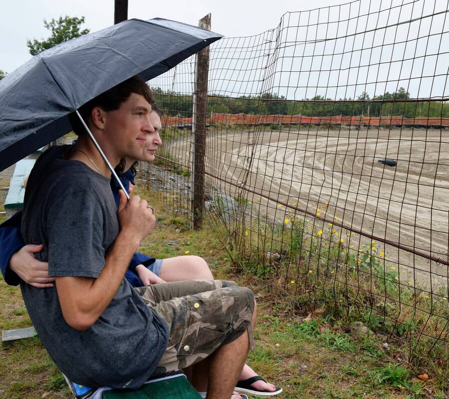 <p>KEVIN MCBAIN PHOTO</p><p>Racing fans Nick Skoreyko and Rebecca Delaney wait out the rain during a delay in the stock car racing at the Roughneck Off Road Racing facility near Liverpool.</p>