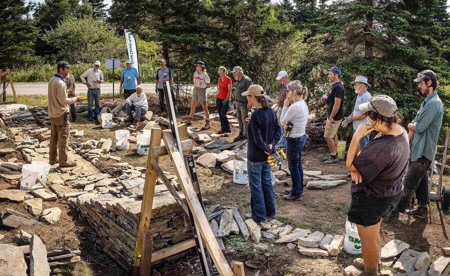 <p>PHOTO BY PAUL NEWTON</p><p>Workshop participants learn how to build a rock wall using no adhesive or any way to keep the rocks connected.</p>