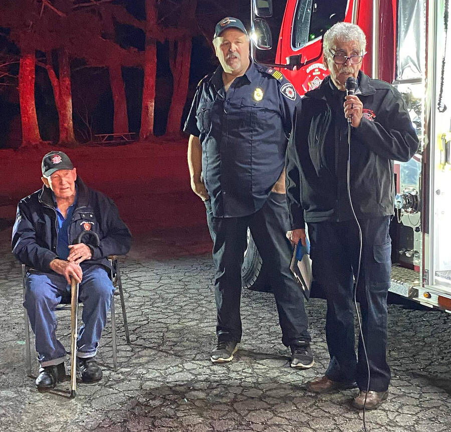 <p>CONTRIBUTED PHOTO</p><p>Chaplain Charlie Greer, of the Greenfield and District Volunteer Fire Department, blesses the new fire truck prior to the &#8220;push-in&#8221; ceremony to put the new truck into service Jan. 2. With him, standing, is Fire Chief Moyal Conrad and former chief, Harry Nelson.</p>