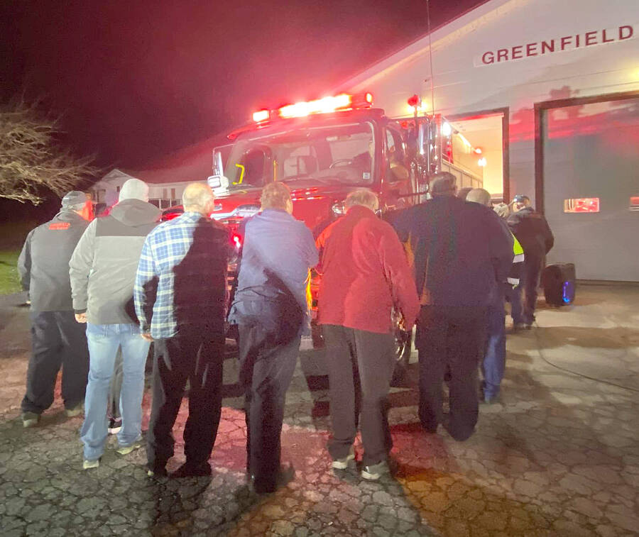<p>CONTRIBUTED PHOTO</p><p>Firefighters of the Greenfield and District Volunteer Fire Department and community members ceremoniously push the new fire truck into the station during a push-in ceremony Jan. 2 to officially put the new fire truck into service.</p>