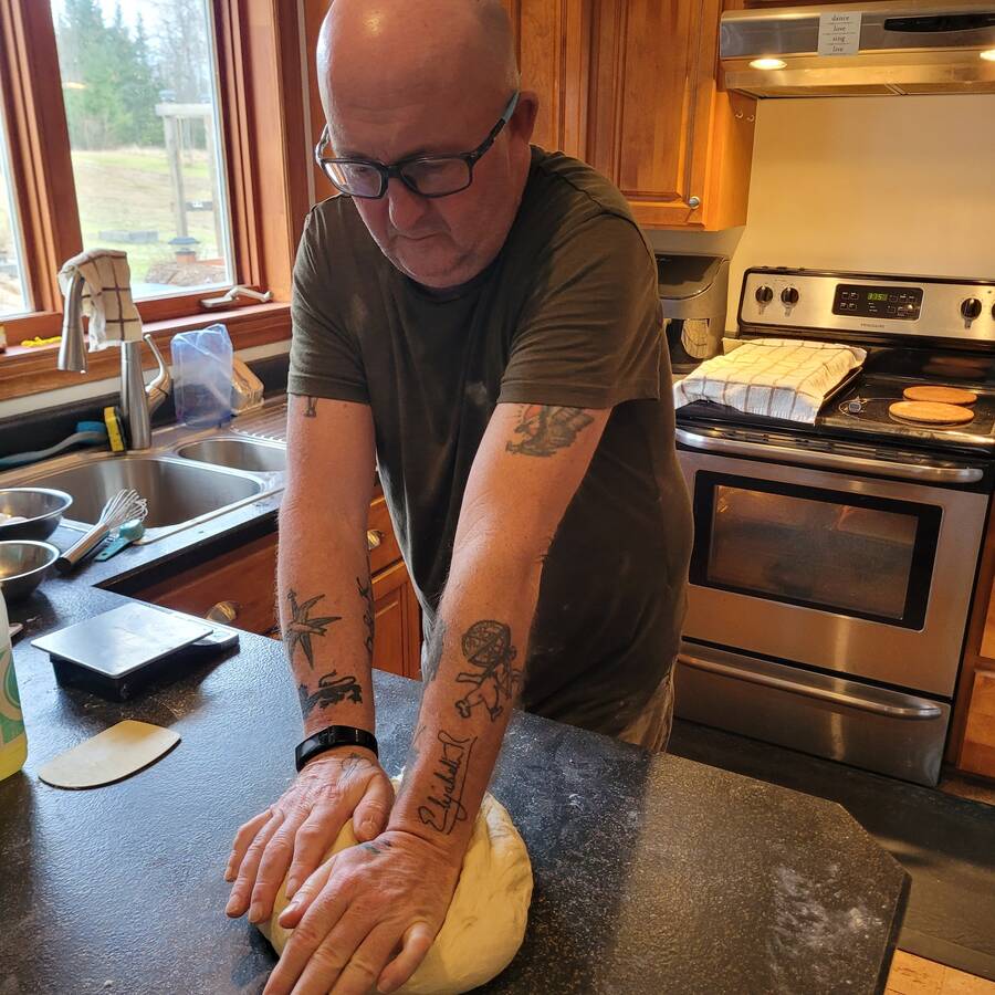 <p>CONTRIBUTED PHOTO</p><p>David Jarvis, who started We Feed Lunenburg, prepares some fresh bread for the Lunenburg food bank.</p>