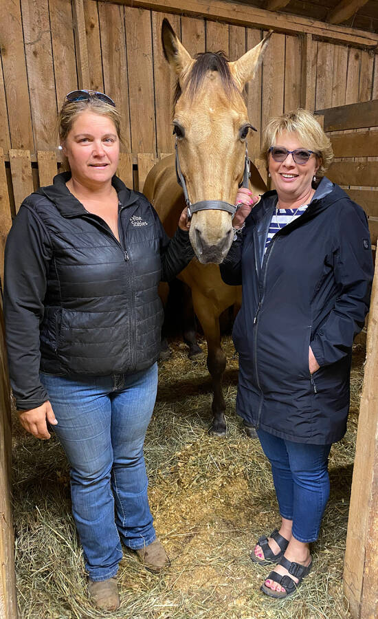 <p>Kevin McBain PHOTO</p><p>Cindy Wamboldt (left) with one of her 16 horses that she brought in for safety reasons to the South Shore Exhibition grounds that were opened up to her and others by manager Tammy Rowter (right). A fire on the New Elm Road in Chelsea, had started near her place Tuesday.</p>