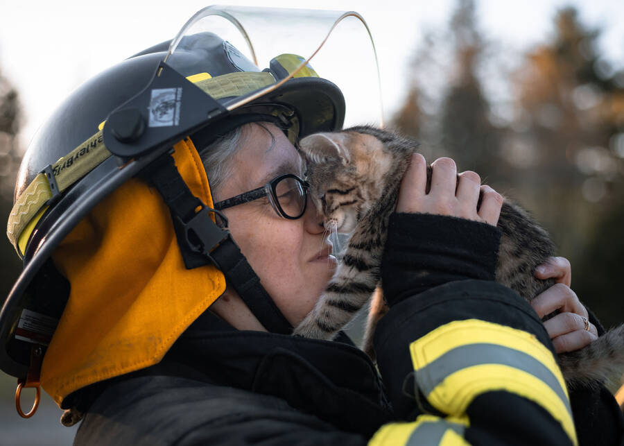 <p>Caroline Hale PHOTOGRAPHY</p><p>A volunteer firefighter from Blockhouse and District Fire Department shares a special moment with SHAID kitten, River.</p>