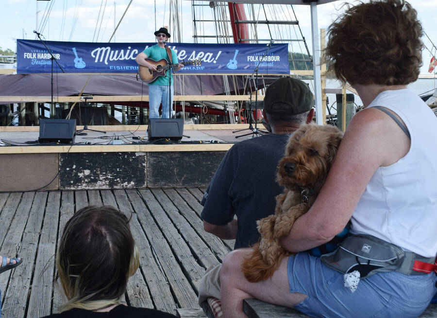 <p>Singer Darcy Scott performs on the Wharf stage.</p>