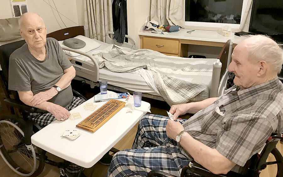 <p>SUBMITTED PHOTO</p><p>Charlie Teal, left, and St. Clair Bolivar play cribbage at Shoreham Village in Chester.</p>